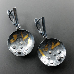 Round blackened sterling silver earrings with 23.5K gold and white topaz