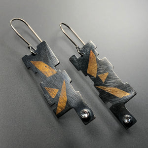 Geometric earrings in 23.5K gold, sterling silver, and white topaz.